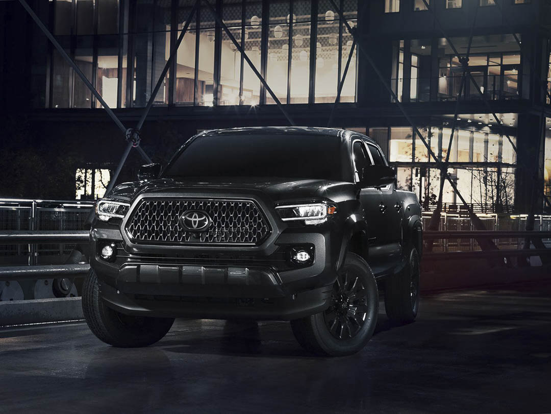 Black 2021 Toyota Tacoma in an industrial building.
